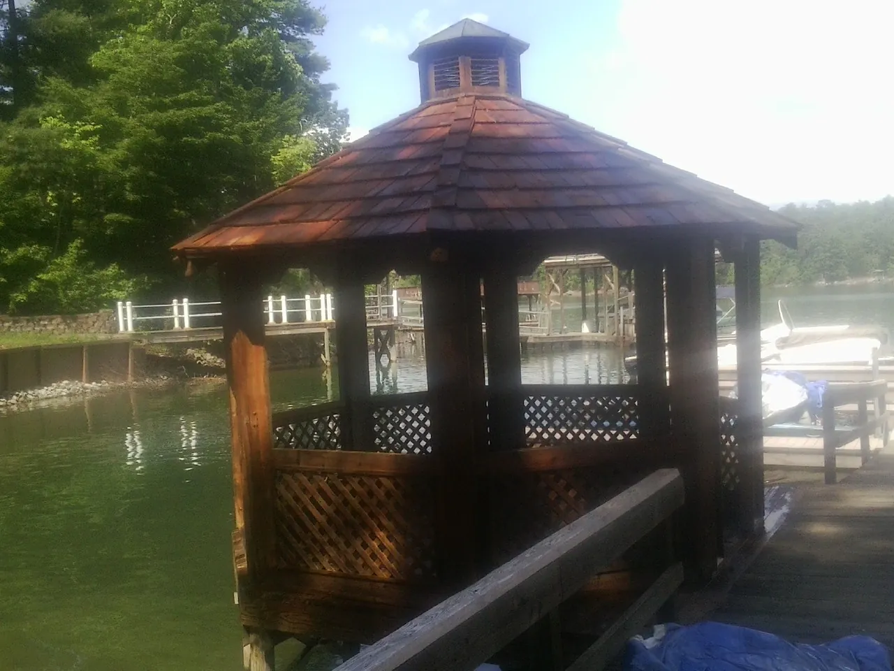 Cedar shake gazebo roof rebuilt on a lake dock in Riverton