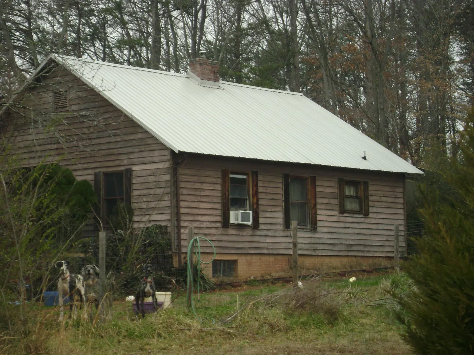 White metal roof on an old wood sided farmhouse, from a Metal Roof Installation job in Riverton